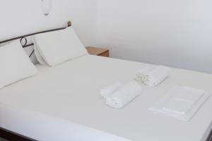 Postel nebo postele na pokoji v ubytování Nikos Rooms