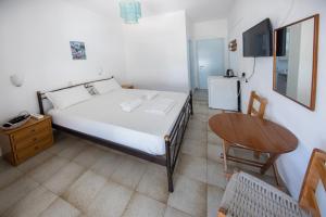 Postel nebo postele na pokoji v ubytování Nikos Rooms