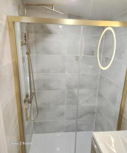 a shower with a glass door in a bathroom at 1-Bed Studio with Parking Ideal for Couples in Newcastle upon Tyne +11 photos