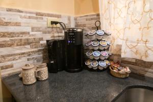 a kitchen counter with a coffee maker and cups at Casa Cicada Sleeps 4 with Balcony in Jerningham Junction
