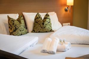 Postel nebo postele na pokoji v ubytování Hotel Langhof