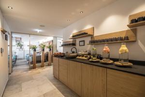 a kitchen with a counter with bottles of wine at Boutiquehotel die Alpbacherin 4 Sterne Superior in Alpbach
