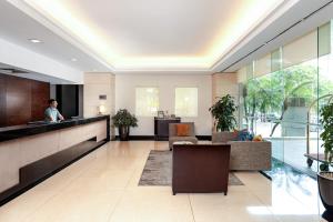 a lobby of a hotel with a person standing in the lobby at Somerset Hoa Binh Hanoi in Hanoi +43 photos