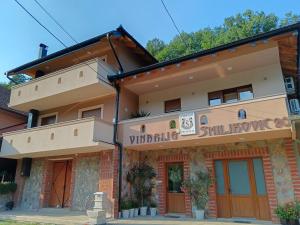 a building with a sign on the front of it at Apartmani Smiljković90 in Aleksandrovac