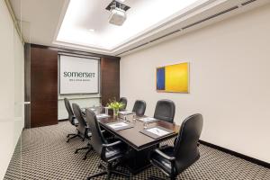 a conference room with a table and chairs at Somerset Hoa Binh Hanoi in Hanoi +35 photos
