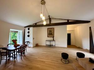 a living room with a dining room table and chairs at Château de Belleaucourt in Coulommes-la-Montagne