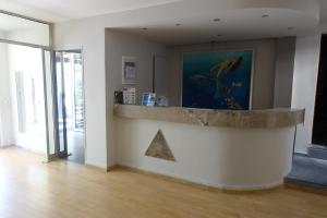 a room with a counter and a pyramid on the wall at Bristol Apartments in Kos Town