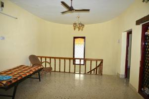 a living room with a ceiling fan and a window at Bhaksaran Home Stay in Tuticorin