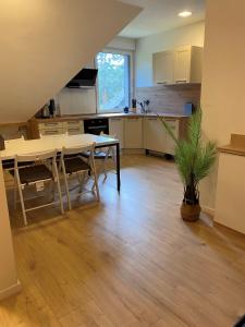 a kitchen with a table and a dining room at Villa Arche 2 in Neuenkirchen-Vörden