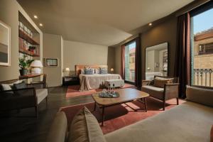 a hotel room with a bed and a living room at Hotel Can Alomar in Palma de Mallorca