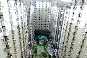 an overhead view of a courtyard between tall buildings at Good Choice 2BR at 12th Floor Gateway Ahmad Yani Cicadas Apartment By Travelio in Bandung