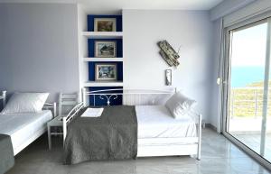 Postel nebo postele na pokoji v ubytování Filikouri Rooms
