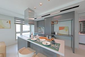 a kitchen with a island in the middle at Elmomento Songdo in Busan