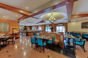 a restaurant with tables and chairs and a bar at Quality Inn Regency, Nashik in Nashik