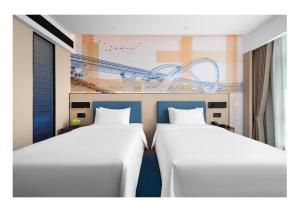 Postel nebo postele na pokoji v ubytování 南宁兴宁希尔顿欢朋酒店 Hampton by Hilton Nanning Xingning