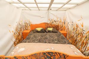 a bed in a room with tall grass at Garden Clamping in Tallinn +135 photos