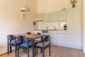 a kitchen with a table and chairs in a room at Beach appartement 40 in Callantsoog