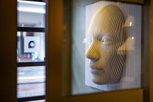 a statue of a head behind a window at Albus Hotel Amsterdam City Centre in Amsterdam