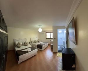 a living room with two couches and a table at Gite jnanefes in El Jadida