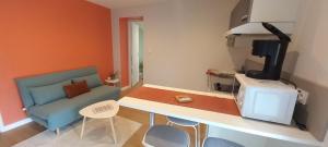 a room with a kitchen with a couch and a table at Mini Pountils in Le Sequestre