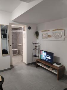 a living room with a television on a table at Magistic Handi in Perpignan