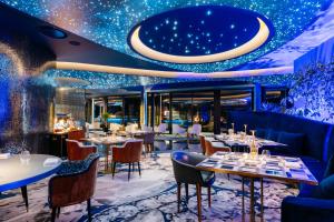 a restaurant with tables and chairs and a ceiling with stars at Savoy Palace - The Leading Hotels of the World - Savoy Signature in Funchal