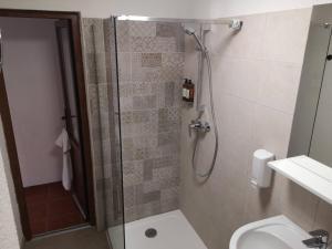 un bagno con doccia, wc e lavandino di Aterman's Cottages a Perşani