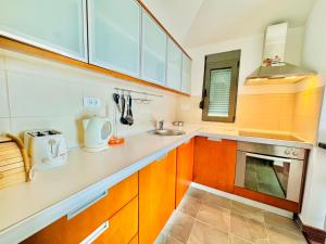 a kitchen with wooden cabinets and a sink at Orahovac sunny port in Kotor