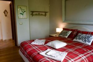 a bedroom with a bed with two towels on it at CascinaMirta in Andorno Micca