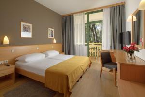 Postel nebo postele na pokoji v ubytování Hotel Aurora Plava Laguna