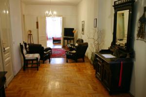 a living room with people sitting in chairs and a mirror at Pepermint in Osijek