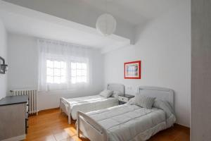 a living room with two beds and a couch at Casa Pilara in Lousame