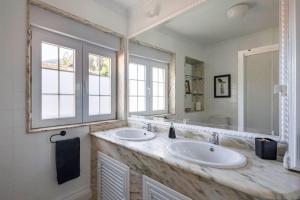 a bathroom with two sinks and a large mirror at Casa Pilara in Lousame +47 photos
