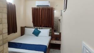 a small room with a bed and a window at Hotel Fab International in Kolkata