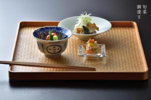 two bowls of food and chopsticks on a tray at Oni no Sumika in Izu +37 photos