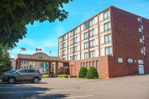 a hotel with a car parked in front of it at Quality Inn & Suites Downtown in Charlottetown