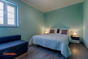 a bedroom with a bed and a window and a couch at Luxury and modern villa with pool near beach by Traveler tourist agency Krk - ID 2138 in Vrh