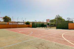 a tennis court with a net on top of it at Chalet en Algeciras Con Piscina, Paddle a 4 Minutos de Playa de Getares in Algeciras