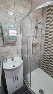 a bathroom with a shower and a sink and a shower at The Garden Room in Hednesford +24 photos