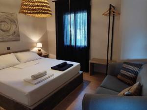 a bedroom with a large bed and a couch at Rodoessi in Korissia