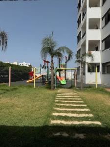 a park with a playground with a slide at Appartement à louer Complexe City Center in Oued Laou