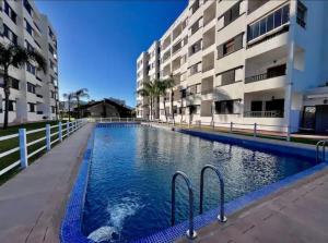 a swimming pool in front of a building at Appartement à louer Complexe City Center in Oued Laou