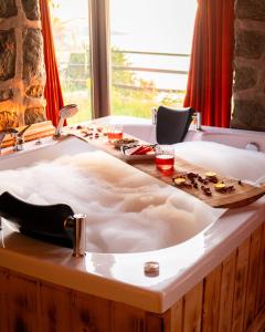 a bath tub in a room with a window at Şahmaran Bungalov in Ardeşen