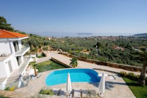 a view of a villa with a swimming pool at Hillside Villa - Pnoe in Limenas +47 photos
