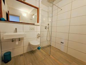 a bathroom with a toilet and a sink and a shower at Robinson Merlot in Bogomolje