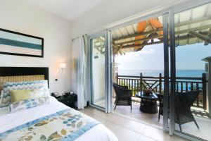 Ένα ή περισσότερα κρεβάτια σε δωμάτιο στο Pearle Beach Resort & Spa
