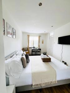 a bedroom with two beds and a flat screen tv at Studio Apartment (St Katherine’s and Wapping) in London
