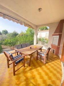 a wooden table and chairs on a patio at Casa del Fico in Santa Caterina di Nardò
