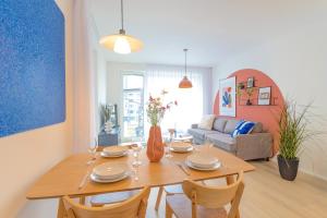 a living room with a wooden table and chairs at Design Apartment - Balcony, Free Parking, Yoga, 10 mins to center, by Gravity Prague in Prague