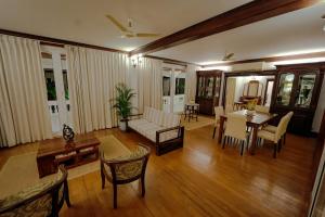 a living room with a couch and a table at Observatory by Chakolas Pavilion in Cochin